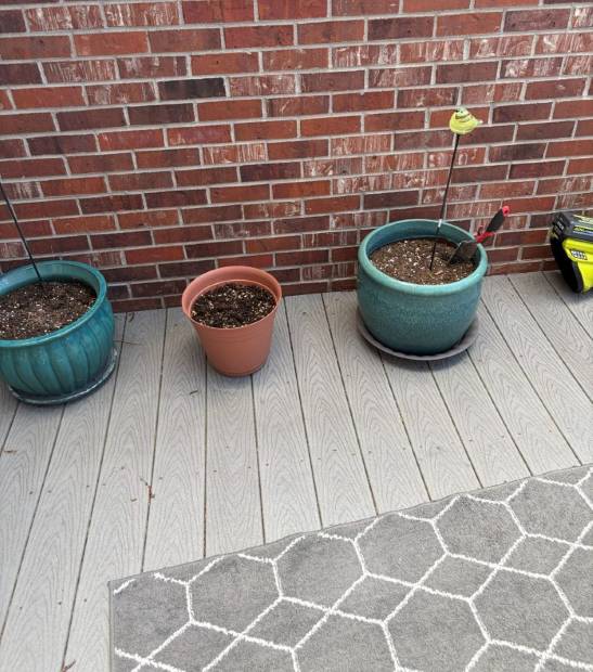 Empty glazed containers on a deck before planting
